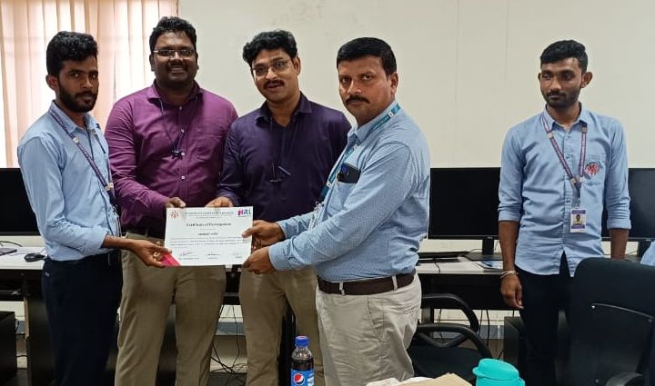Faculty and MRL trainer presenting a certificate to a student at the close of a programme